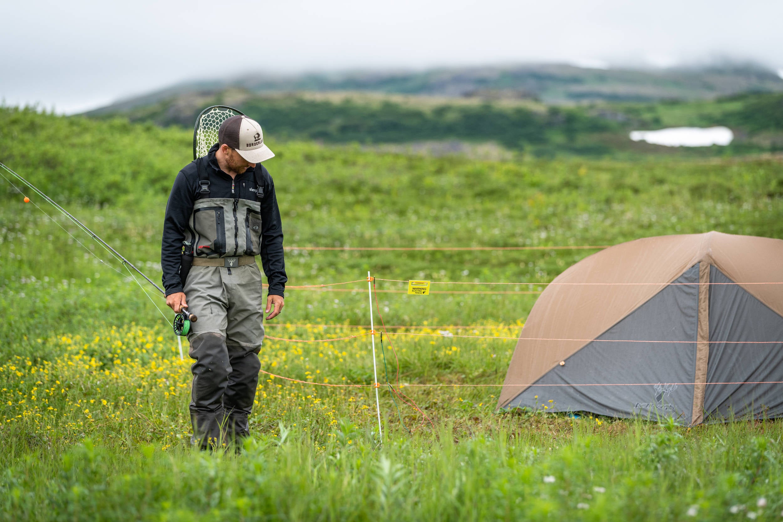 Fisherman with his portable electric fence set up